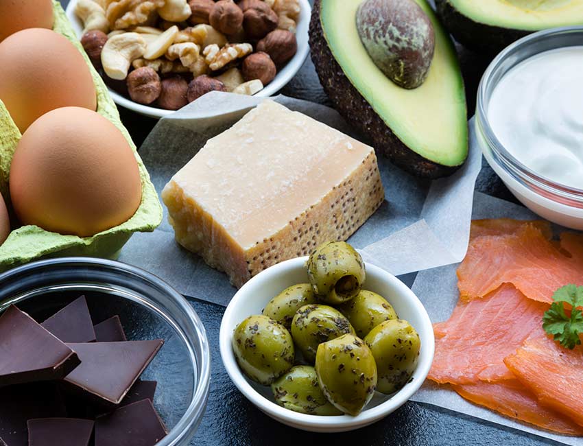 This is a table top shot of food items high in healthy fats.